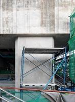 The front view of the large column of the monorail station is under construction with the scaffolding. photo