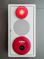 Fire alarm system on the white concrete wall . photo
