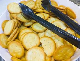 Salty crackers in the white bowl. photo