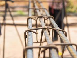 Vintage style photo of selective focused steel rods in reinforced concrete column preparation in construction site.