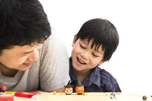 Father is playing Halloween clay with his son over white background photo