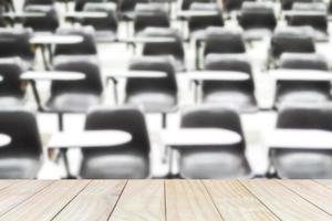 Wooden plank floor over blurred of empty lecture room photo