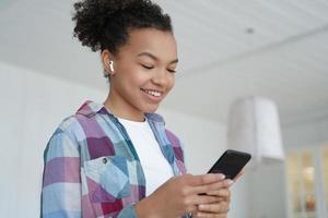 Music listening in airpods. Teenage girl enjoying favourite song in wireless earphones. photo