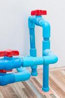 Red plastic valve on the PVC pipe photo