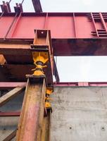 The large iron framework is installing on the top of the reinforcement concrete pole. photo