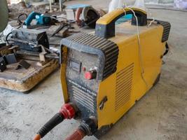 The old inverter welding machine on the concrete floor. photo