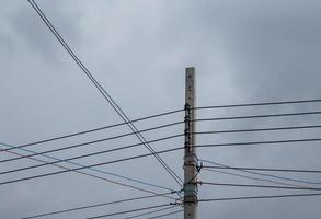 Electric concrete pole with the complex cable. photo