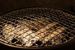 Round metal grille on the charcoal stove. photo