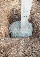 The cement mixed with stones in the concrete pillar holes. photo