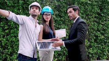 Solar power plant Engineers Team standing and discussion solar panel project together video