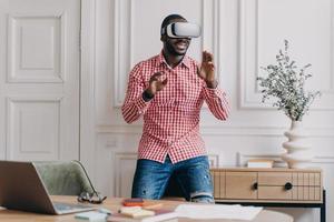 African man in VR headset interacting with digital interface, using innovative device for business photo