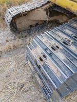 Closeup of the dirty crawler with the dry mud from the paddy field. photo