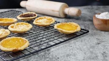 hands arranging delicious homemade pie on a cooling rack. food preparation concept