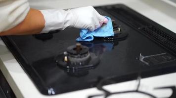 A woman cleaning a gas stove video