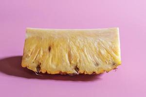 Minimal healthy food pineapple sliced on pink table. photo