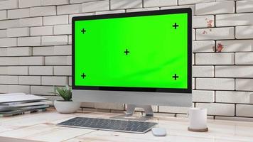 datormockup på skrivbordet på kontoret designad i minimal. kan användas inom utbildning och näringsliv. grön skärm för banner och logotyp. animation, 3d-rendering. video