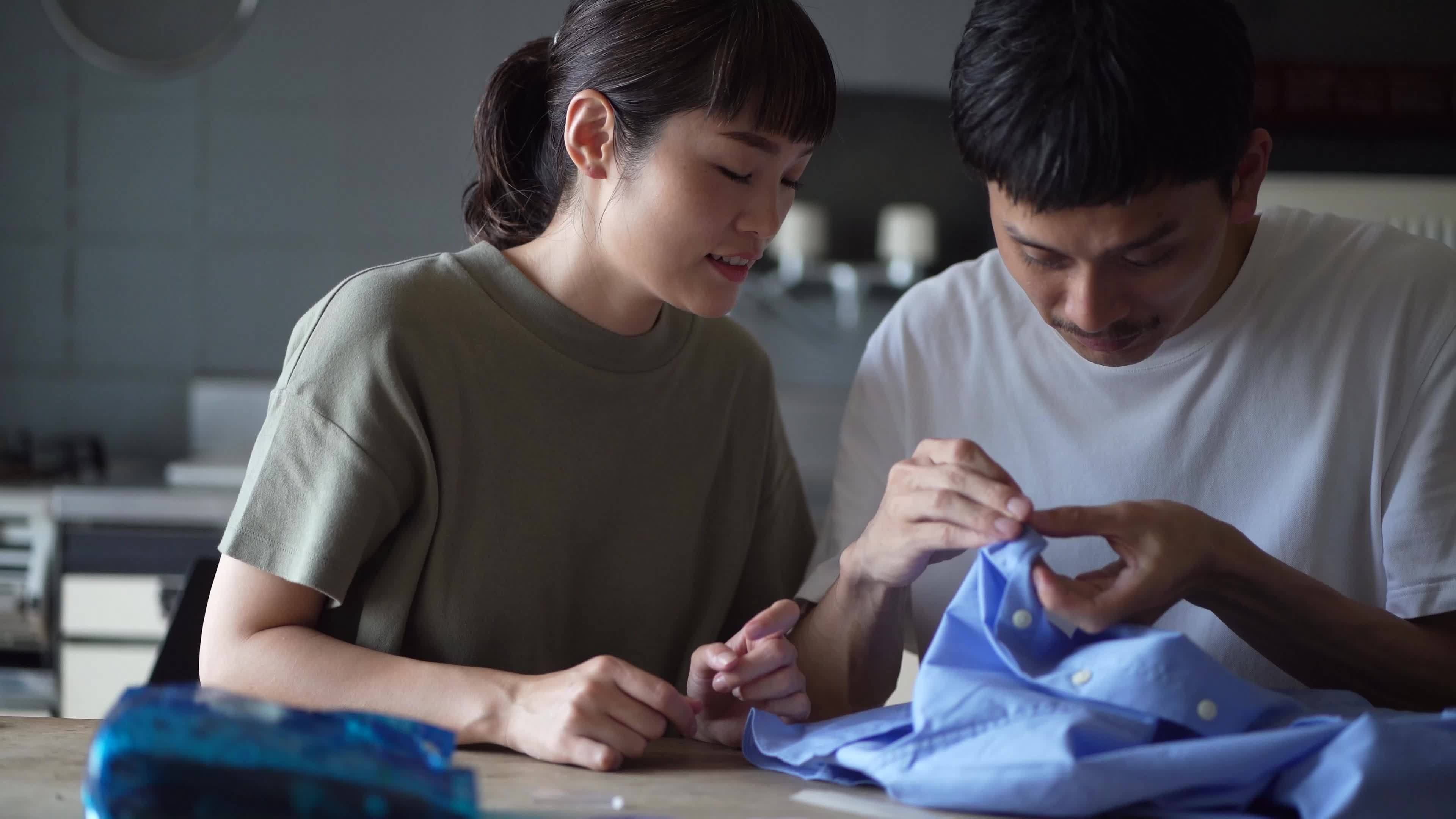 A man who learns how to attach buttons 8843786 Stock Video at Vecteezy