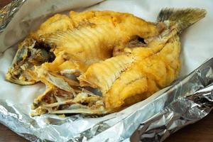 Snapper topped with sauce on a plate photo