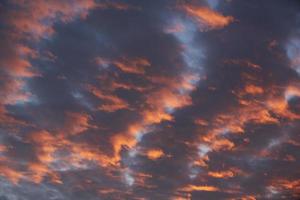 Beautiful orange clouds and blue sky during sunrise photo