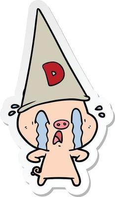sticker of a crying pig wearing dunce hat