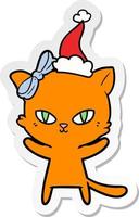 cute sticker cartoon of a cat wearing santa hat vector