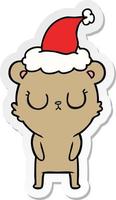 peaceful sticker cartoon of a bear wearing santa hat vector