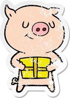 distressed sticker of a happy cartoon pig with christmas present vector