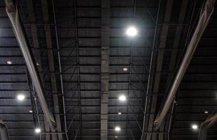 The truss metal frame with the electric bulb system on the ceiling. photo