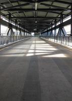 Lonely walkway of the metal frame bridge. photo