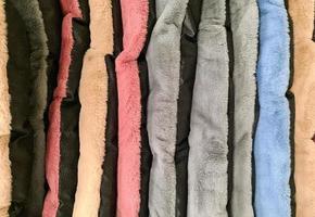 Detailed close up view on samples of cloth and fabrics in different colors found at a fabrics market photo