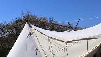 Old vikings tent made of wood and cloth in front of a blue sky