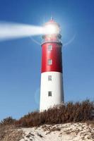 Old lighthouse searchlight beam through marine air. photo