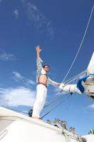 Young man sailing his boat on the open ocean photo