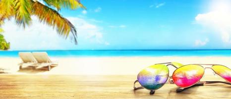 Summer tropical beach background with fashionable sunglasses. photo