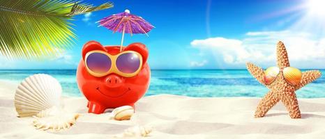 piggy bank with sunglasses on tropical beach - summer holiday. photo