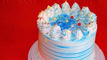 Birthday cake decorated with white and blue icing. photo