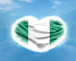 Nigeria flag in heart shape in blue sky photo