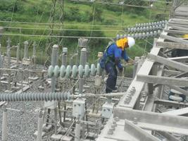 electrician repairing electric tower photo