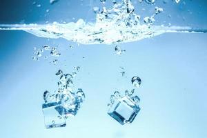 Abstract background image of ice cubes in blue water. photo