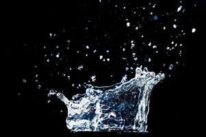 Abstract background of Water splashing on a black background. idea for freshness photo