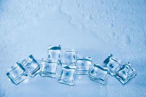 Ice cubes on studio blue background. The concept of freshness with coolness from ice cubes. photo