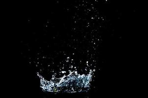 Scattered water splashes on a black background. water splash isolated on the black background photo