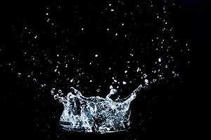 Scattered water splashes on a black background. water splash isolated on the black background photo