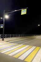 Pedestrian zone on the highway illuminated , at night photo