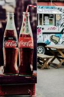 Minsk, Belarus, June 2022- refrigerator with  classic Coca-Cola bottle. photo