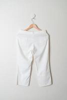 trousers or long pants hanging on wall photo