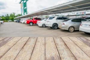 wood table top with cars in parking lot photo