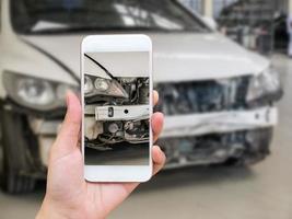 woman holding smartphone and take photo of car accident