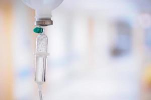 Medical drip with hospital blurred background photo