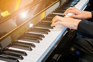 Close up musician hand playing piano photo